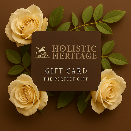 Holistic Heritage gift card surrounded by soft yellow roses and fresh green leaves on a warm brown background.